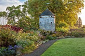 LLANOVER GARDEN, MONMOUTHSHIRE: WALLED, ROUND GARDEN, OCTOBER, BORDER, LAWN, PATH, DOVECOTE, GRASSES, PERENNIALS, SALVIAS, DAHLIA DAVID HOWARD, ASTER LITTLE CARLOW