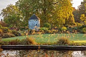 LLANOVER GARDEN, MONMOUTHSHIRE: WALLED, ROUND GARDEN, POND, OCTOBER, LAWN, PATH, DOVECOTE, GRASSES, PERENNIALS, STIPA GIGANTEA