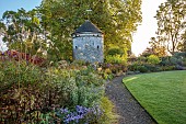 LLANOVER GARDEN, MONMOUTHSHIRE: WALLED, ROUND GARDEN, OCTOBER, BORDER, LAWN, PATH, DOVECOTE, GRASSES, PERENNIALS, SALVIAS, DAHLIA DAVID HOWARD, ASTER LITTLE CARLOW