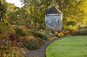 LLANOVER GARDEN, MONMOUTHSHIRE: WALLED, ROUND GARDEN, OCTOBER, BORDER, LAWN, PATH, DOVECOTE, GRASSES, PERENNIALS, SALVIAS, DAHLIA DAVID HOWARD, VITIS COIGNETIAE