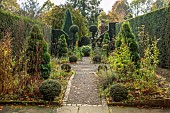 YORK GATE GARDEN, YORKSHIRE: AUTUMN, FALL, THE HERB GARDEN, PATHS, HEDGES, HEDGING, CLIPPED, TOPIARY SPIRAL TOPIARY, YEW, FORMAL, SMALL