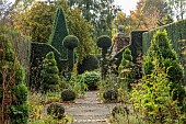 YORK GATE GARDEN, YORKSHIRE: AUTUMN, FALL, THE HERB GARDEN, PATHS, HEDGES, HEDGING, CLIPPED, TOPIARY SPIRAL TOPIARY, YEW, FORMAL, SMALL