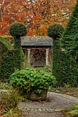 YORK GATE GARDEN, YORKSHIRE: AUTUMN, FALL, VIEW INTOTHE HERB GARDEN, CONTAINER, CLIPPED, TOPIARY, SUMMERHOUSE, BUILDING
