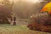 JOHN MASSEY GARDEN, ASHWOOD NURSERIES, WORCESTERSHIRE, FALL, AUTUMN, OCTOBER, TERRACOTTA URN, CONTAINER NEAR THE CANAL, LAWN, MIST, FOG, SUNRISE