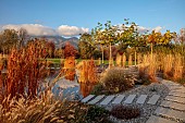 NATURAL SWIMMING POND GARDEN, ITALY BY GPT STUDIO, AUTUMN, OCTOBER, PLATANUS X HISPANICA, DECKING, LOUNGERS, POOL, POND, WATER, STEPPING STONES, GRAVEL