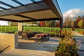 NATURAL SWIMMING POND GARDEN, ITALY BY GPT STUDIO, FALL, AUTUMN, OCTOBER, OUTDOOR, OUTSIDE, INSIDE LIVING ROOM OPEN ON ONE SIDE, TABLE, CHAIRS