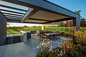 NATURAL SWIMMING POND GARDEN, ITALY BY GPT STUDIO, FALL, AUTUMN, OCTOBER, OUTDOOR, OUTSIDE, INSIDE LIVING ROOM OPEN ON ONE SIDE, TABLE, CHAIRS