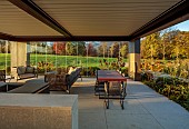 NATURAL SWIMMING POND GARDEN, ITALY BY GPT STUDIO, FALL, AUTUMN, OCTOBER, OUTDOOR, OUTSIDE, INSIDE LIVING ROOM OPEN ON ONE SIDE, TABLE, CHAIRS