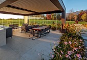NATURAL SWIMMING POND GARDEN, ITALY BY GPT STUDIO, FALL, AUTUMN, OCTOBER, OUTDOOR, OUTSIDE, INSIDE LIVING ROOM OPEN ON ONE SIDE, TABLE, CHAIRS