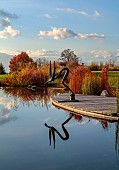 NATURAL SWIMMING POND GARDEN, ITALY BY GPT STUDIO, FALL, AUTUMN, OCTOBER, NATURAL SWIMMING POND, POOL, REFLECTIONS, DECKING, SCULPTURE BY LEON BRONSTEIN