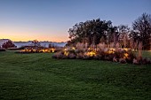 NATURAL SWIMMING POND GARDEN, ITALY BY GPT STUDIO, FALL, AUTUMN, OCTOBER, LAWN, ISLAND BEDS, BORDERS, LIT UP AT NIGHT, EVENING, LIGHTING, LIGHTS