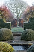 WOLLERTON OLD HALL, SHROPSHIRE: NOVEMBER, FROST, WINTER, PAVING, POOL, POND, WATER, CLIPPED YEW TOPIARY, HEDGES, HEDING, THE LIME ALLEE, FORMAL, GARDEN