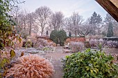 WOLLERTON OLD HALL, SHROPSHIRE: NOVEMBER, FROST, WINTER, LANHYDROCK GARDEN, PATH, GRASSES, FATSIA JAPONICA, WALLS