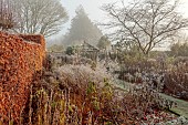 WOLLERTON OLD HALL, SHROPSHIRE: NOVEMBER, FROST, WINTER, SUNDIAL GARDEN, PATH, WOODEN PERGOLA, HERBACEOUS BORDERS