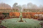 WOLLERTON OLD HALL, SHROPSHIRE: NOVEMBER, FROST, WINTER, STONE SUNDIAL, SUNDIAL GARDEN, FORMAL, COUNTRY, BEECH HEDGES, HEDGING