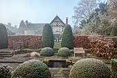 WOLLERTON OLD HALL, SHROPSHIRE: NOVEMBER, FROST, WINTER, VIEW OF HOUSE FROM THE LIME ALLEE, CLIPPED TOPIARY, YEW, BEECH HEDGES, HEDGING, POOL, POND, FORMAL, COUNTRY, GARDEN