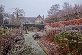 WOLLERTON OLD HALL, SHROPSHIRE: NOVEMBER, FROST, WINTER, HEDGES, HEDGING, PATH, DOUBLE HERBACEOUS BORDERS, SUNDIAL GARDEN