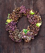 WOLLERTON OLD HALL, SHROPSHIRE: WREATH ON FRONT DOOR, CORYLUS AVELANA, HEDERA, HYDRANGEA MACROPHYLLA WESTFALEN