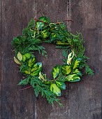 WOLLERTON OLD HALL, SHROPSHIRE: WREATH ON FRONT DOOR, CORNUS SIBERICA, THUJA OCCIDENTALIS, ILEX X ALTACLERENSIS