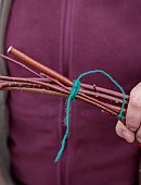WOLLERTON OLD HALL, SHROPSHIRE: WREATH MAKING BY HEAD GARDENER CLAIRE TATLER, CORNUS SIBERICA STEMS TWISTED AND THEN TIED TOGETHER WITH STRING