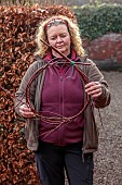 WOLLERTON OLD HALL, SHROPSHIRE: WREATH MAKING BY HEAD GARDENER CLAIRE TATLER, CORNUS SIBERICA STEMS TWISTED AND THEN TIED TOGETHER WITH STRING