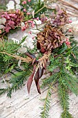 WOLLERTON OLD HALL, SHROPSHIRE: WREATH MAKING, CORNUS SIBERICA, YEW, HYDRANGEA WESTFALEN, CALAMAGROSTIS BRACHYTRICHA, EUONYMUS HAMILTONIANUS, ENKIANTHUS CERNUUS RUBENS