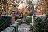 THE LASKETT GARDEN, HEREFORDSHIRE: WINTER, FROST, JANUARY, CLIPPED TOPIARY YEW, HEDGES, HEDGING, STATUE OF BRITANNIA, TOPIARY YEW