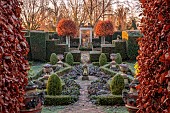 THE LASKETT GARDEN, HEREFORDSHIRE: WINTER, FROST, JANUARY, SILVER JUBILEE GARDEN, BOX PARTERRE, SUNDIAL, BERGENIA, PIERPONT MORGAN ROSE GARDEN, CLIPPED BEECH TREES