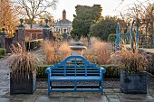 THE LASKETT GARDEN, HEREFORDSHIRE: WINTER, FROST, JANUARY, THE COLONNADE COURT, PARTERRE BEDS WITH URNS, GRASSES, BLUE BENCH, SEAT