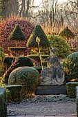 THE LASKETT GARDEN, HEREFORDSHIRE: WINTER, FROST, JANUARY, CLIPPED TOPIARY YEW, HEDGES, HEDGING, STATUE OF BRITANNIA, TOPIARY YEW