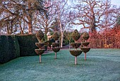 THE LASKETT GARDEN, HEREFORDSHIRE: WINTER, FROST, JANUARY,YEW TOPIARY CHESS PIECES IN THE CHESS GARDEN, LAWN