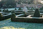HELMINGHAM HALL GARDENS, SUFFOLK: WINTER, FROST, JANUARY, BOX PARTERRE, CLIPPED TOPIARY, HEGDES, HEDGING, STONE URN
