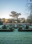 HELMINGHAM HALL GARDENS, SUFFOLK: WINTER, FROST, JANUARY, BOX PARTERRE, CLIPPED TOPIARY, HEGDES, HEDGING, STONE URN