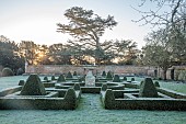 HELMINGHAM HALL GARDENS, SUFFOLK: WINTER, FROST, JANUARY, BOX PARTERRE, CLIPPED TOPIARY, HEGDES, HEDGING, STONE URN