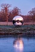 HELMINGHAM HALL GARDENS, SUFFOLK: WINTER, FROST, JANUARY, MOAT, DAVID HARBER SUNDIAL, REFLECTED, REFLECTIONS