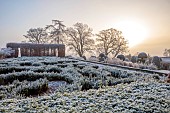 BROUGHTON GRANGE GARDENS, OXFORDSHIRE: WINTER, FROST, JANUARY, PARTERRE, HORNBEAM HEDGES, HEDGING, SUNRISE