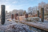BROUGHTON GRANGE GARDENS, OXFORDSHIRE: WINTER, FROST, JANUARY, RILL, WATER, CLIPPED, TOPIARY, CUPRESSUS SEMPERVIRENS, ITALIAN CYPRESS, BEECH TOPIARY, FAGUS SYLVATICA