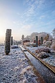 BROUGHTON GRANGE GARDENS, OXFORDSHIRE: WINTER, FROST, JANUARY, RILL, WATER, CLIPPED, TOPIARY, CUPRESSUS SEMPERVIRENS, ITALIAN CYPRESS, BEECH TOPIARY, FAGUS SYLVATICA