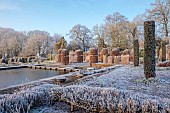 BROUGHTON GRANGE GARDENS, OXFORDSHIRE: WINTER, FROST, JANUARY, POOL, POND, WATER, CLIPPED, TOPIARY, CUPRESSUS SEMPERVIRENS, ITALIAN CYPRESS, BEECH TOPIARY, FAGUS SYLVATICA