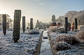 BROUGHTON GRANGE GARDENS, OXFORDSHIRE: WINTER, FROST, JANUARY, RILL, TOPIARY, CUPRESSUS SEMPERVIRENS, ITALIAN CYPRESS, BEECH TOPIARY, FAGUS SYLVATICA, WATER, RILL