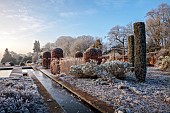 BROUGHTON GRANGE GARDENS, OXFORDSHIRE: WINTER, FROST, JANUARY, RILL, TOPIARY, CUPRESSUS SEMPERVIRENS, ITALIAN CYPRESS, BEECH TOPIARY, FAGUS SYLVATICA, WATER, RILL