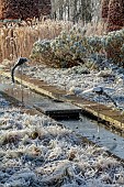 BROUGHTON GRANGE GARDENS, OXFORDSHIRE: WINTER, FROST, JANUARY, RILL, STEPPING STONE, DRAGONFLY SCULPTURE