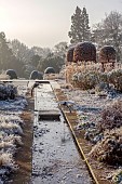 BROUGHTON GRANGE GARDENS, OXFORDSHIRE: WINTER, FROST, JANUARY, RILL, STEPPING STONE, DRAGONFLY SCULPTURES, BEECH, FAGUS SYLVATICA