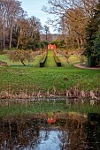 PAINSWICK ROCOCO GARDEN, GLOUCESTERSHIRE: THE RED HOUSE SEEN FROM THE LAKE, POND, WATER, GARDEN BUILDING, FEBRUARY, REFLECTIONS, REFLECTED