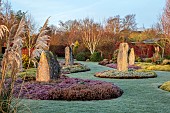 HOLME FOR GARDENS, DORSET, FEBRUARY, HENGE GARDEN, HOLME HENGE, STONE CIRCLE OF PURBECK STONE MONOLITHS, HEATHERS, PINES, WINTER GARDEN