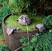 HALF BARREL WATER FEATURE: SUBMERGED BRONZE HEAD WATERSPOUT AND HANDS BY DENNIS FAIRWEATHER. HAMPTON COURT SHOW 1996