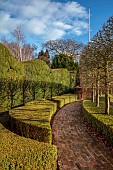 LITTLETHORPE MANOR, YORKSHIRE, FEBRUARY, WINTER GARDEN: BRICK PATH, CLIPPED BOX, YEW, PLEACHED HORNBEAM, HEDGING, HEDGES