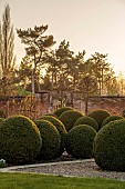 MORTON HALL GARDENS, WORCESTERSHIRE: VIEW INTO WALLED GARDEN, MARCH, CLIPPED TOPIARY BOX BALLS, BUXUS