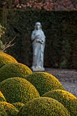 MORTON HALL GARDENS, WORCESTERSHIRE: VIEW INTO WALLED GARDEN, MARCH, CLIPPED TOPIARY BOX BALLS, BUXUS, STATUE