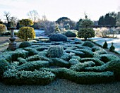 THE KNOT GARDEN IN FROST  WITH SUNDIAL AND CLIPPED BALLS OF GOLDEN KING HOLLY  ILEX X ALTACLERENSIS. BARNSLEY HOUSE  GLOUCS.